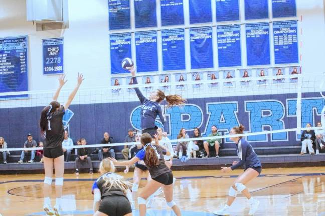 Sparta's Sylvia Przydzial (7) jumps high and strikes the ball above the net. She made three kills, two digs, six service points and two aces.