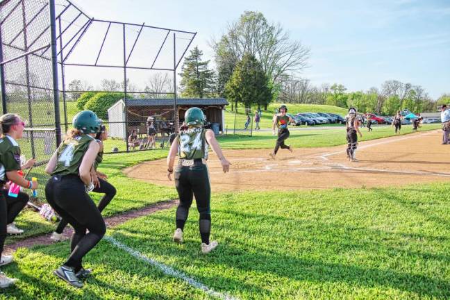 ST1 Sussex Tech runner Alexandra Sweetman crosses home plate to score as her teammates wait to celebrate in the seventh inning May 7. The Mustangs defeated Wallkill Valley, 10-8, in Hamburg. (Photos by George Leroy Hunter)