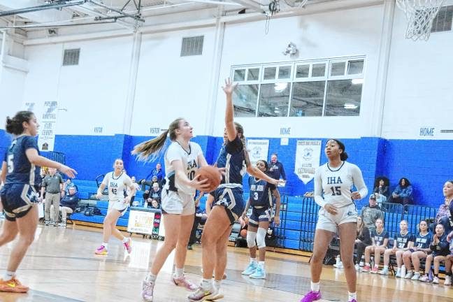 Immaculate Heart's Casey McCauley handles the ball under tight coverage from Pope John's Cailey Fitzmorris in the first half. McCauley scored 12 points.