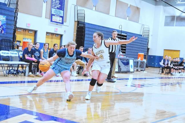 Sparta's Katie Sutton handles the ball while being shadowed by a River Dell defender. She scored 17 points.