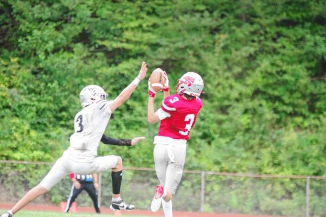 <b>Wallkill Valley defensive back Kellan Brown's reach fails to disrupt the catch by High Point receiver Mark Leach. Leach made two receptions for 41 yards.</b>