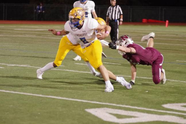 Lyndhurst ball carrier Roddy Morinho is on the run in the first half.