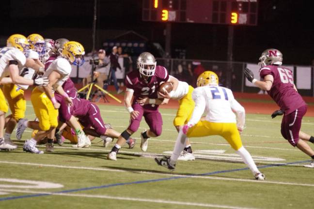 In the first half, Newton ball carrier Nick Kurilko tries to evade defenders. He made 12 tackles on defense.