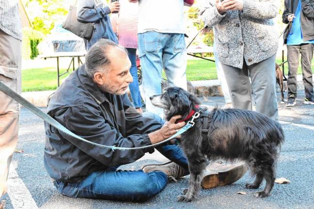 The Rev. Dr. Jack DiMatteo blesses a dog named Maverick. (Photo by Maria Kovic)