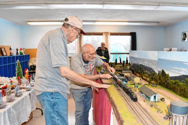 Sussex County Railroad Club members Noel Phillips, left, and Dave Rutan set up the model train displays.