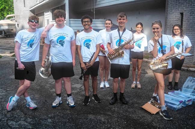 Members of the Sparta High School Marching Spartans relax before the parade.