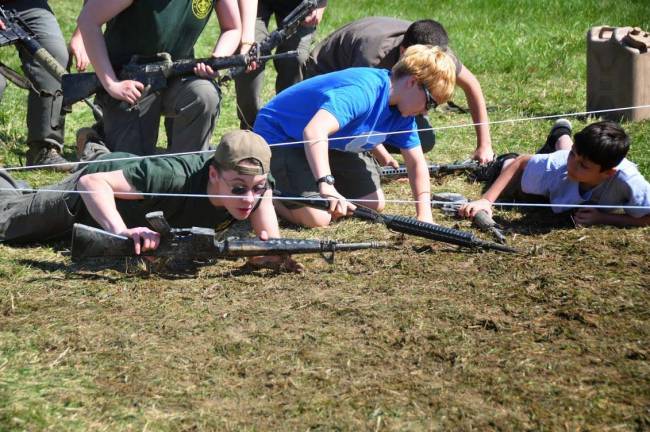 Scouts running the West Point obstacle course.