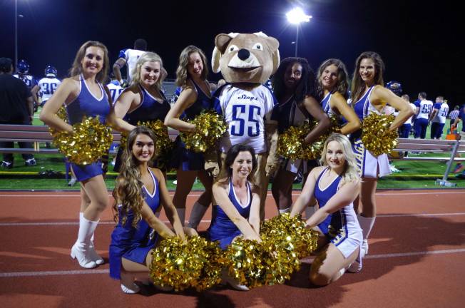 The Sussex Stags Dance Team pose with Bucky the mascot for a portrait.