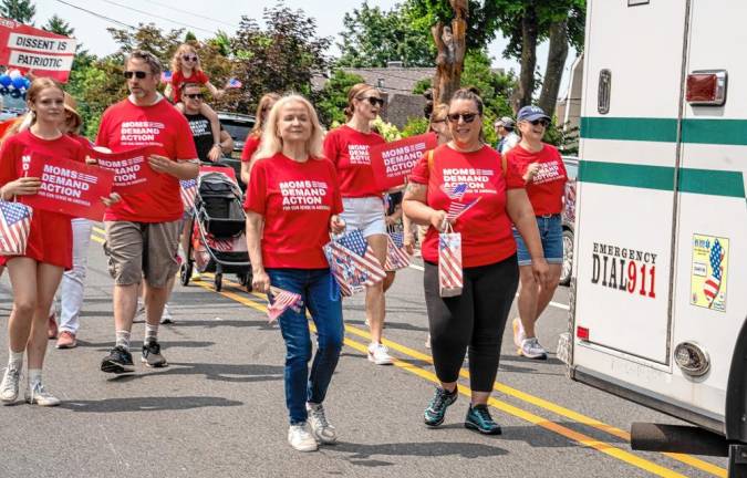 Members of Mom Demand Action participate in the parade.