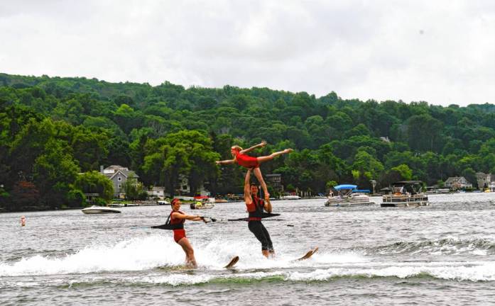 Kate Sutphen, left, is on her swivel ski as Carter Higgins performs a straps lift with Saige Lieb.