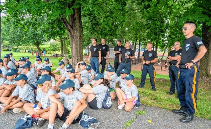 Sparta police officers watch a Junior Police Academy session.