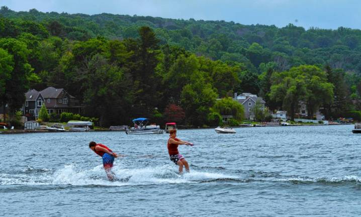 Two-ski trick skiers Lincoln Andres and Ben Parnell perform turns.