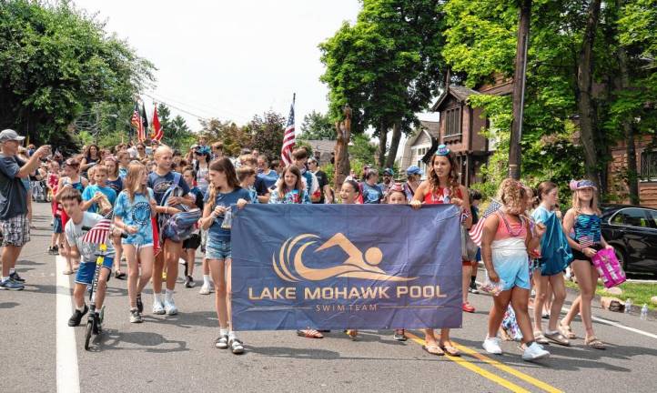 Members of the Lake Mohawk Pool swim team march in the parade.