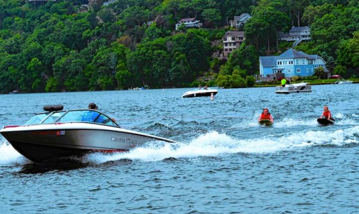 A boat pulls Mackenzie Reid and Marina Lieb on their kneeboards.