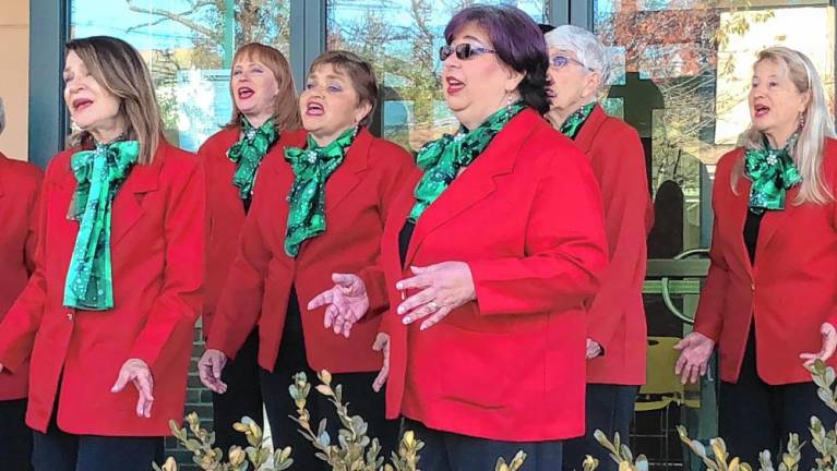 The a cappella group Harmony in Motion sings carols at the event.