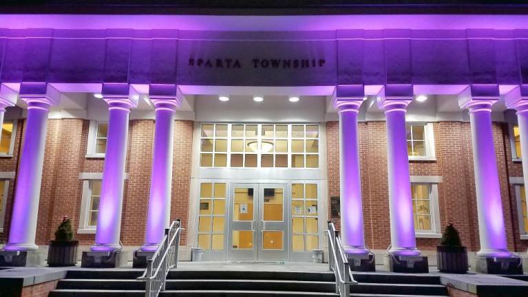 Township Hall is illuminated in purple on Feb. 14, 2020 in celebration of League of Women Voters Day in Sparta.