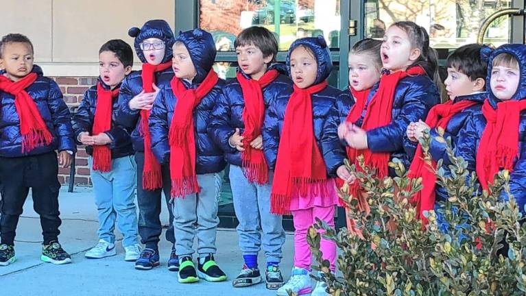 Students at Project Self-Sufficiency’s Little Sprouts Early Learning Center sing a holiday song.