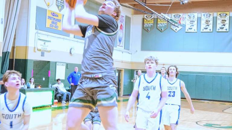 ST1 Sussex Tech's Brian Gruber rises toward the net during a shot in the fourth quarter of the game against South Hunterdon on Jan. 4. South Hunterdon won, 76-51, and Gruber scored 21 points. (Photos by George Leroy Hunter)