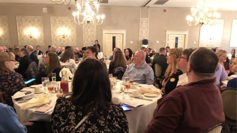 Robert Boyle, fourth from right, is seated at the Planet Networks table at the chamber awards luncheon. (Photo by Kathy Shwiff)